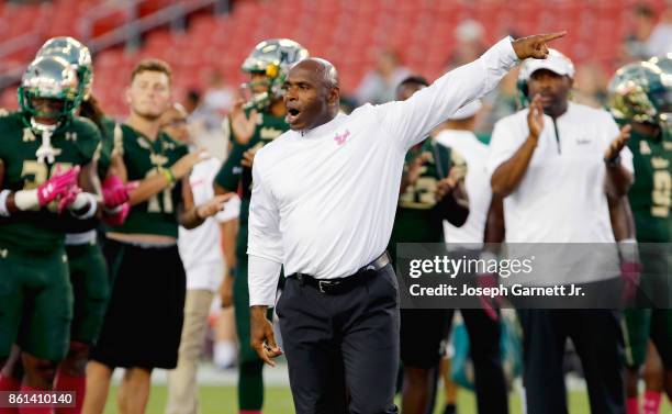 Head coach Charlie Strong of the South Florida Bulls gives directions to his team during warmups prior to their game against the Cincinnati Bearcats...