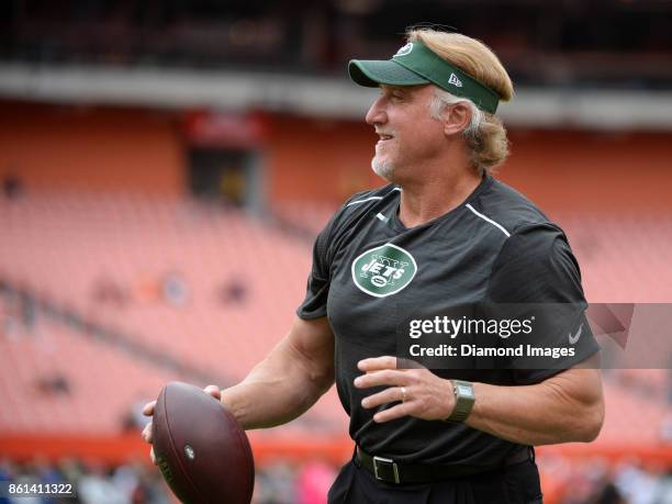 Outside linebackers coach Kevin Greene of the New York Jets throws a pass as he plays catch with a fan prior to a game on October 8, 2017 against the...