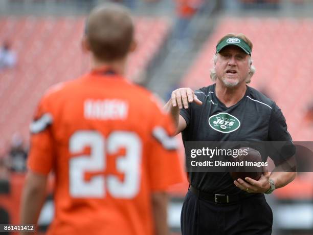 Outside linebackers coach Kevin Greene of the New York Jets plays catch with a fan prior to a game on October 8, 2017 against the Cleveland Browns at...