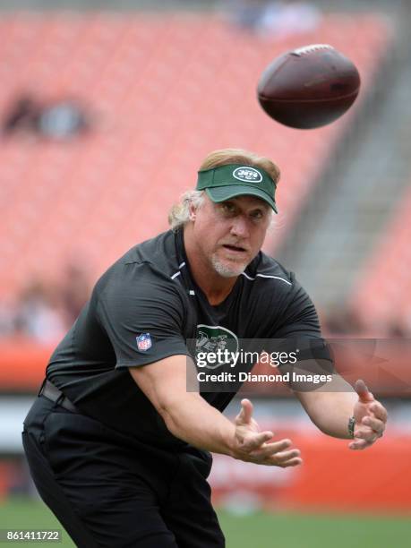 Outside linebackers coach Kevin Greene of the New York Jets catches a pass as he plays catch with a fan prior to a game on October 8, 2017 against...