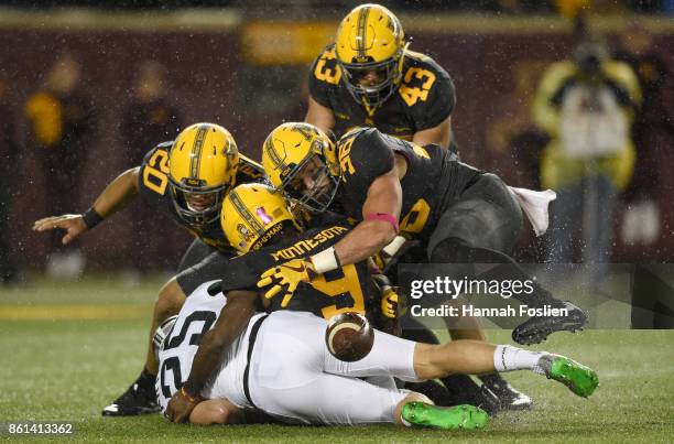 Jake Hartbarger of the Michigan State Spartans fumbles the ball on a punt attempt during the first quarter of the game against the Minnesota Golden...