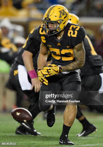 Shannon Brooks of the Minnesota Golden Gophers fumbles the ball against the Michigan State Spartans during the first quarter of the game on October...