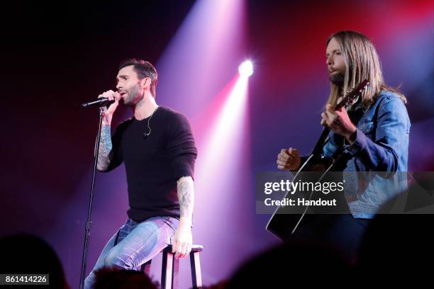 In this handout photo provided by One Voice: Somos Live!, Adam Levine and James Valentine of Maroon 5 perform onstage during "One Voice: Somos Live!...