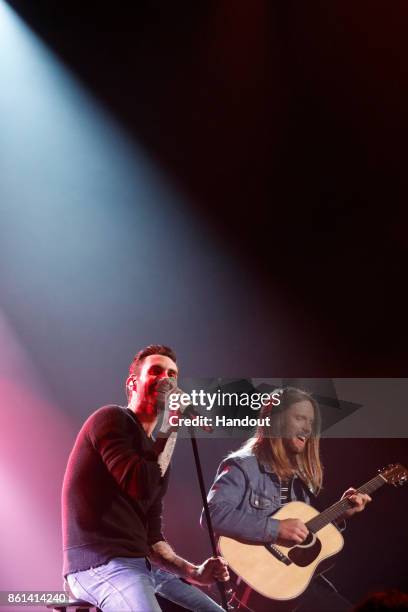 In this handout photo provided by One Voice: Somos Live!, Adam Levine and James Valentine of Maroon 5 perform onstage during "One Voice: Somos Live!...