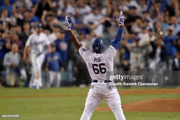 Yasiel Puig of the Los Angeles Dodgers celebrates after hitting a double to center field to score Logan Forsythe against Jose Quintana of the Chicago...