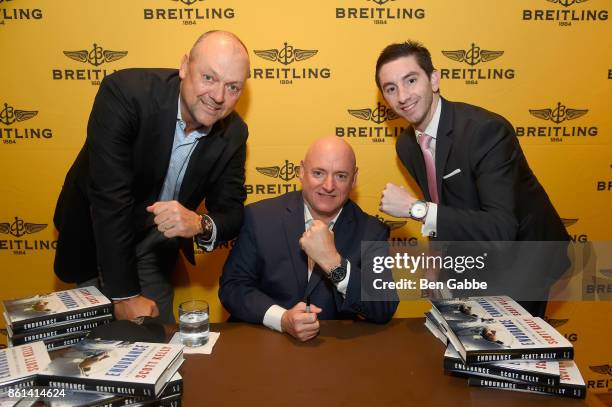 Breitling USA President Thierry Prissert and Retired Astronaut Scott Kelly pose with a guest during Breitling Celebrates Former NASA Astronaut and...