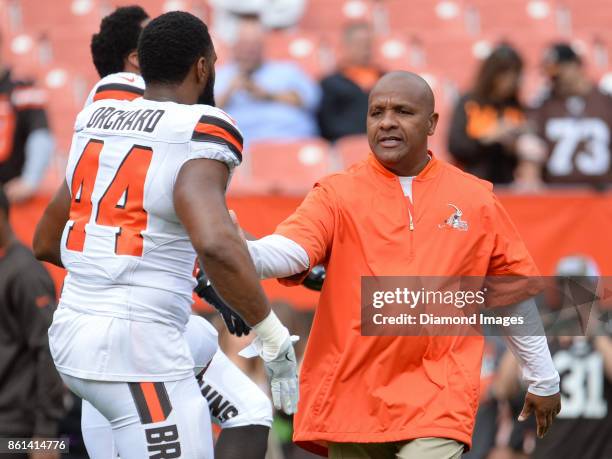 Head coach Hue Jackson of the Cleveland Browns shakes hands with defensive lineman Nate Orchard prior to a game on October 8, 2017 against the New...