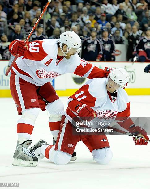 Dan Cleary of the Detroit Red Wings is congratulated by Henrik Zetterberg after his goal against the Columbus Blue Jackets during Game Three of the...