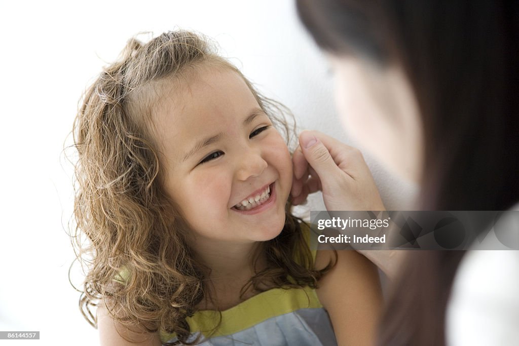 Girl looking at mother, smiling