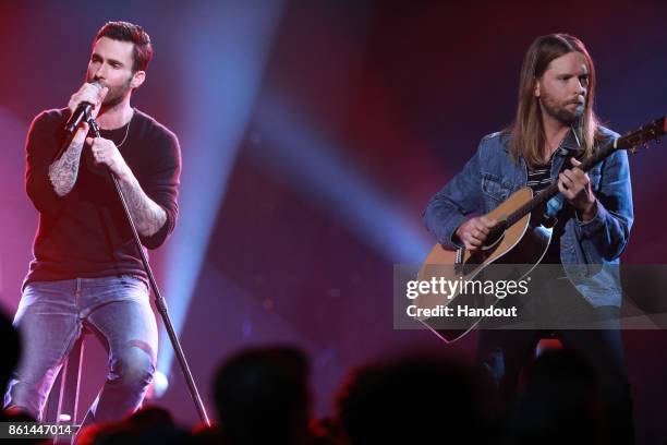 In this handout photo provided by One Voice: Somos Live!, Adam Levine and James Valentine of Maroon 5 perform onstage during "One Voice: Somos Live!...