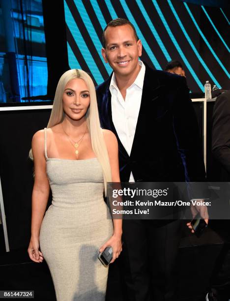 In this handout photo provided by One Voice: Somos Live!, Kim Kardashian and Alex Rodriguez participate in the phone bank onstage during "One Voice:...