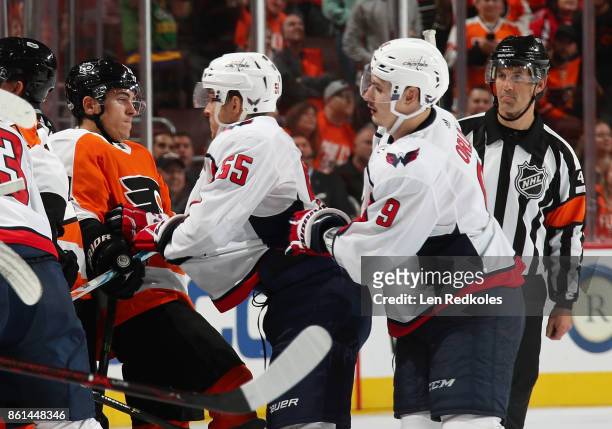 Travis Konecny of the Philadelphia Flyers scuffles with Aaron Ness and Dmitry Orlov of the Washington Capitals on October 14, 2017 at the Wells Fargo...