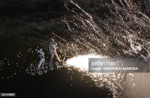 Dancers perform in a show of fireworks at Rodrigo de Freitas Lagoon in Rio de Janeiro, Brazil on April 21 during the opening of the celebrations of...