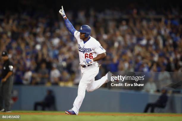 Yasiel Puig of the Los Angeles Dodgers celebrates after hitting a home run in the bottom of the seventh inning during Game One of the National League...