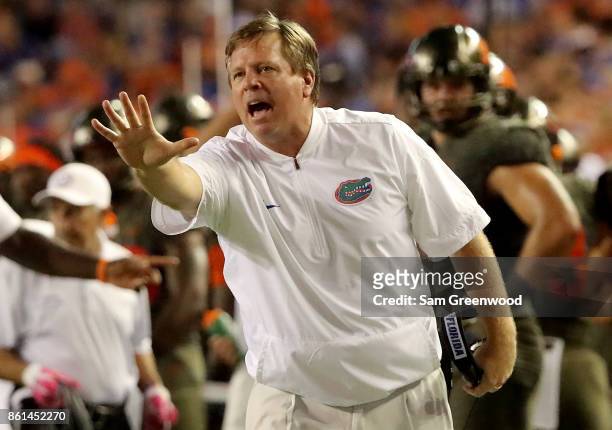 Head coach Jim McElwain of the Florida Gators signals to his players during the game against the Texas A&M Aggies at Ben Hill Griffin Stadium on...