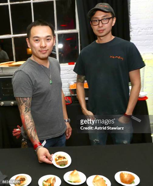 Chef Davis Ngo displaying the "Hog" sandwich and chef Alan Woo attend Street Eats hosted by Ghetto Gastro at Industria on October 14, 2017 in New...