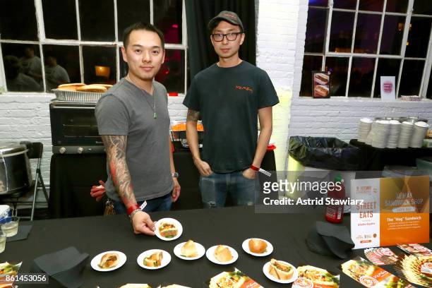 Chef Davis Ngo displaying the "Hog" sandwich and chef Alan Woo attend Street Eats hosted by Ghetto Gastro at Industria on October 14, 2017 in New...