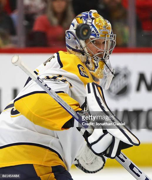 Pekka Rinne of the Nashville Predators looks at the puck after making a save with his stick against the Chicago Blackhawks at the United Center on...