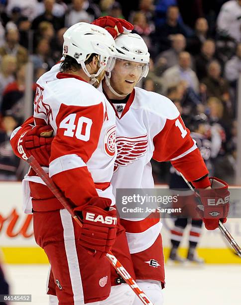 Henrik Zetterberg of the Detroit Red Wings celebrates his empty net goal with Dan Cleary against the Columbus Blue Jackets during Game Three of the...