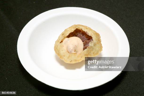 View of a dish served by Pondicheri, Pomegranate Pani Poori, during Street Eats hosted by Ghetto Gastro at Industria on October 14, 2017 in New York...