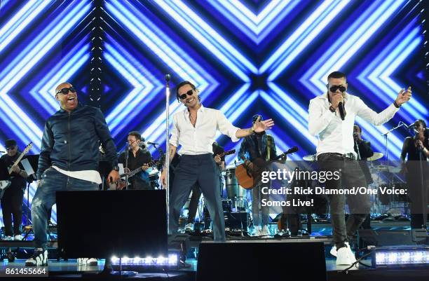 In this handout photo provided by One Voice: Somos Live!, Alexander Delgado, Marc Anthony and Randy Malcom Martinez perform onstage at One Voice:...