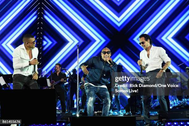 In this handout photo provided by One Voice: Somos Live!, Alexander Delgado, Marc Anthony and Randy Malcom Martinez perform onstage at One Voice:...