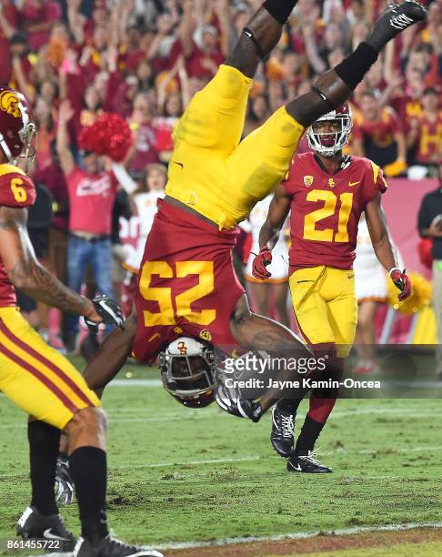Running back Ronald Jones II of the USC Trojans is upended by defensive back Marquise Blair of the Utah Utes as he flips into the end zone for the go...