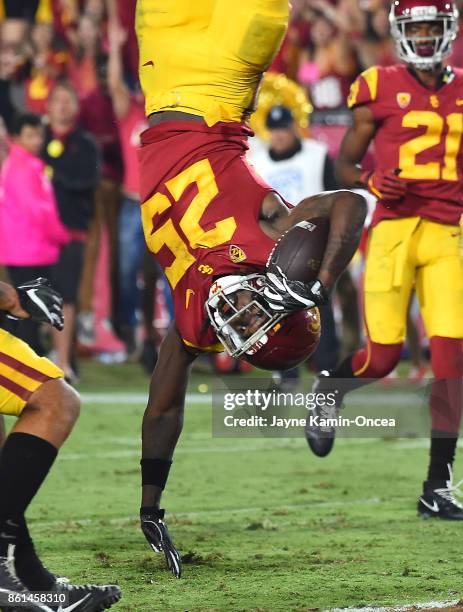 Running back Ronald Jones II of the USC Trojans is upended by defensive back Marquise Blair of the Utah Utes as he flips into the end zone for the go...