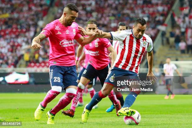 Mario Osuna of Morelia and Edwin Hernandez of Chivas fight for the ball during the 13th round match between Chivas and Morelia as part of the Torneo...