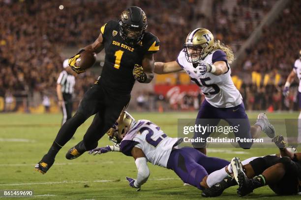 Wide receiver N'Keal Harry of the Arizona State Sun Devils runs with the football after a reception past defensive back Jordan Miller and linebacker...