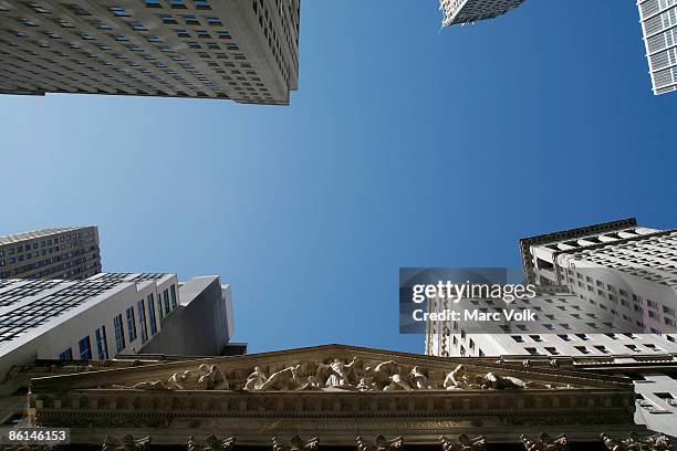 low angle view of the sky above wall street - wall street photos et images de collection