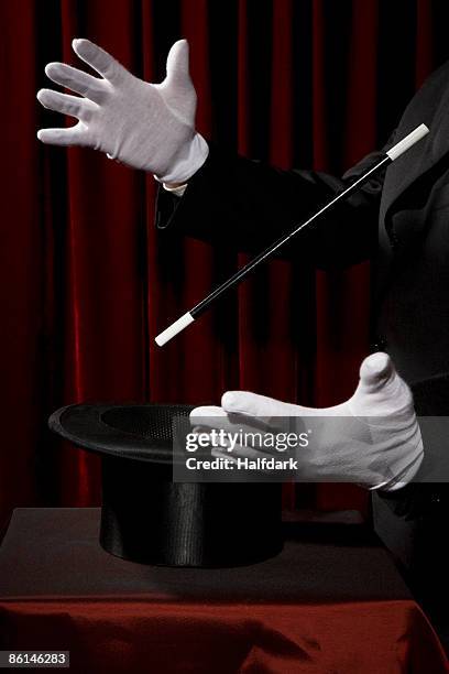 a magician's gloved hands performing a magic trick - formal glove stock-fotos und bilder