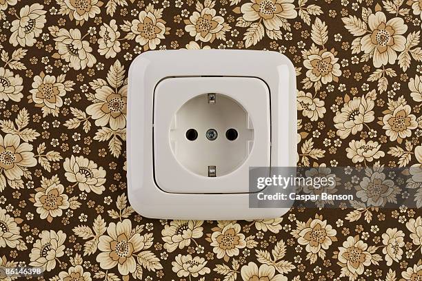 an outlet on wallpaper - steckdose stock-fotos und bilder