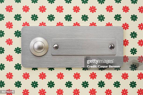 a door buzzer and name plate fixed to a wallpapered wall - doorbell stock pictures, royalty-free photos & images