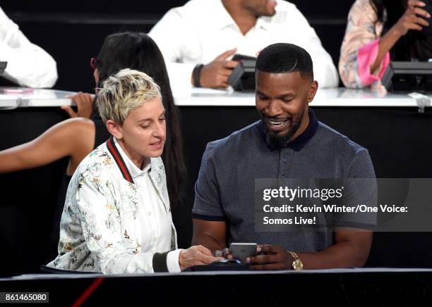 In this handout photo provided by One Voice: Somos Live!, tv personality Ellen DeGeneres and actor Jamie Foxx participate in the phone bank onstage...
