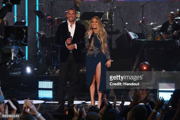 In this handout photo provided by One Voice: Somos Live!, Alex Rodriguez and Jennifer Lopez speak onstage during "One Voice: Somos Live! A Concert...