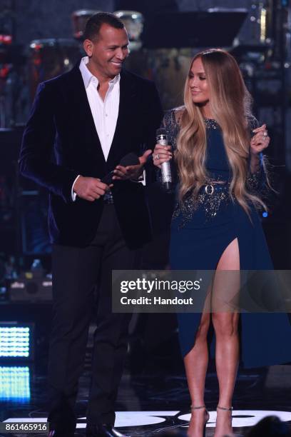 In this handout photo provided by One Voice: Somos Live!, Alex Rodriguez and Jennifer Lopez speak onstage during "One Voice: Somos Live! A Concert...