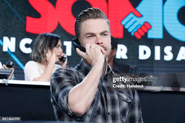 In this handout photo provided by One Voice: Somos Live!, Derek Hough participates in the phone bank during "One Voice: Somos Live! A Concert For...