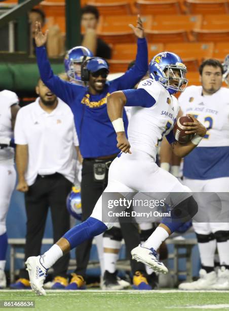 Quarterback Montel Aaron of the San Jose State Spartans runs down the sideline during the first quarter of the game against the Hawaii Rainbow...