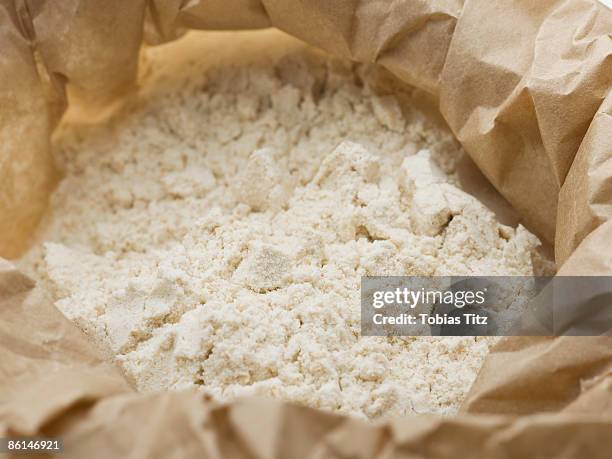 flour in a paper bag - flour bag stockfoto's en -beelden