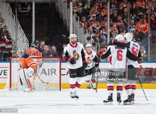 Zack Smith, Chris Wideman and Mike Hoffman of the Ottawa Senators celebrate a goal against the Edmonton Oilers on October 14, 2017 at Rogers Place in...