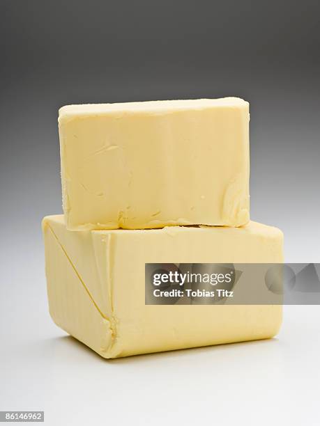 two pieces of butter - butter stock pictures, royalty-free photos & images