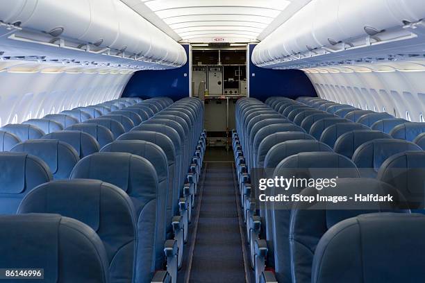 the empty cabin of an airplane - interiors stock pictures, royalty-free photos & images