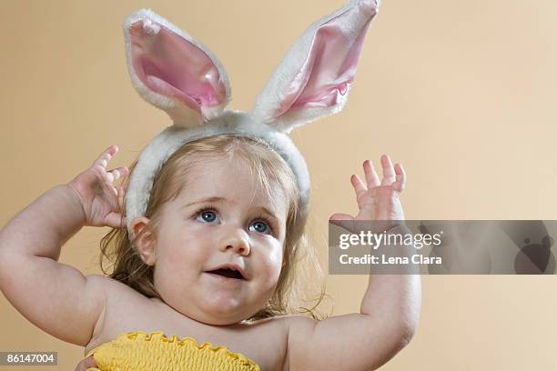 a young girl wearing a rabbit-ear hair band - rabbit mouth stock pictures, royalty-free photos & images
