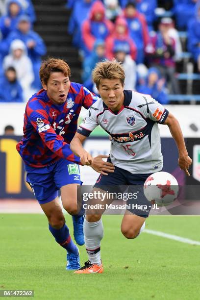 Kensuke Nagai of FC Tokyo and Ryo Shinzato of Ventforet Kofu compete for the ball during the J.League J1 match between Ventforet Kofu and FC Tokyo at...