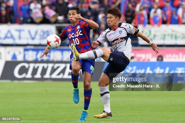 Kosuke Ota of FC Tokyo and Dudu of Ventforet Kofu compete for the ball during the J.League J1 match between Ventforet Kofu and FC Tokyo at Yamanashi...