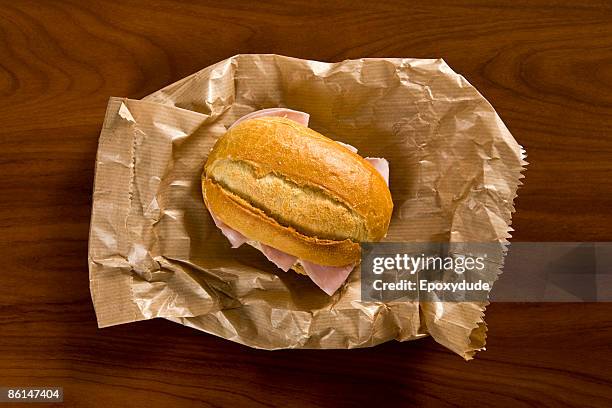 a sandwich sitting on a brown paper bag - sandwich top view stock pictures, royalty-free photos & images