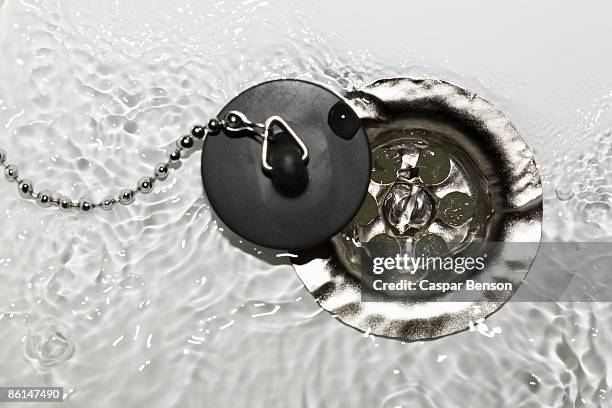 water running into a drain - water plug stock pictures, royalty-free photos & images