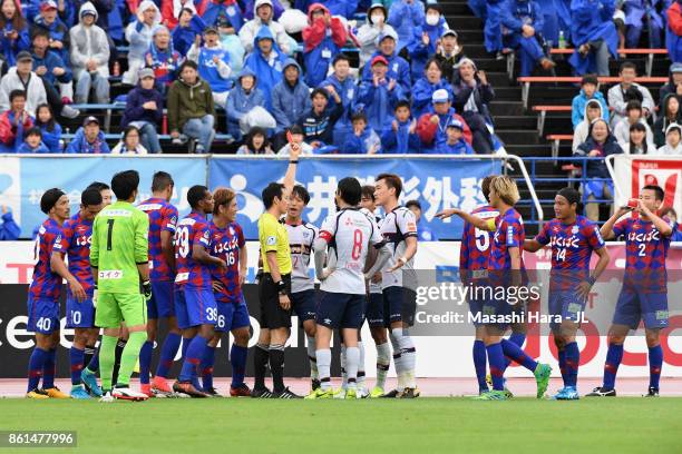 Referee Hiroyuki Kimura shows a red card to Peter Utaka of FC Tokyo during the J.League J1 match between Ventforet Kofu and FC Tokyo at Yamanashi...