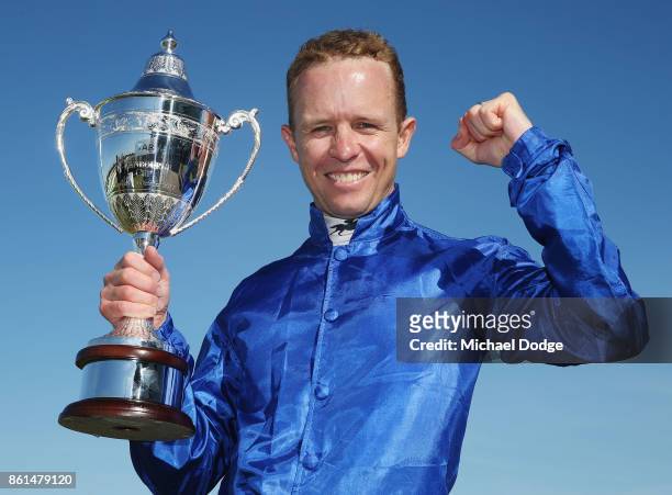 Jockey Kerrin McEvoy poses with his trophy after riding Folkswood to win race 8 the TAB Cranbourne Cup during Cranbourne Cup Day at on October 15,...